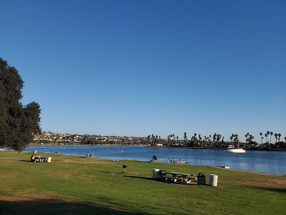 De Anza Cove is in the far northeast corner of Mission Bay.  It is a small, sheltered cove with a large grassy area. De Anza Cove is a perfect place for large gatherings.  The beach area has a dedicated swimming with seasonal lifeguards. Directly south of the cove there are more motor sports activities.  The De Anza Boat Launch is actually outside the cove in the Mission Bay Park parking lot. Mission Bay RV Resort and Campland on the Bay are on De Anza Cove.  The Mission Bay Golf course is next to the cove.